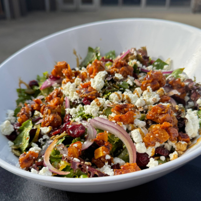 a picture of butternut squash with salad and feta cheese